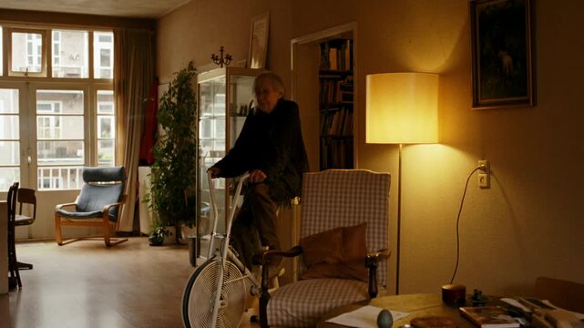 Senior woman with long hair staying active and healthy by pedaling on a custom exercise bicycle