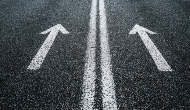Asphalt road with double white line and two forward arrows