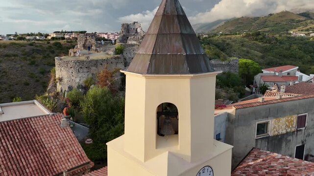 Horizontal FHD view of a church bell tower with an ancient fortress in Scalea, Italy,