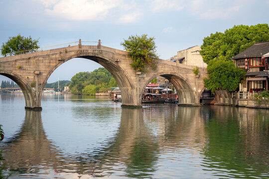 Traditional Chinese stone bridge over an ancient water canal in a village in a Zhujiajao, China