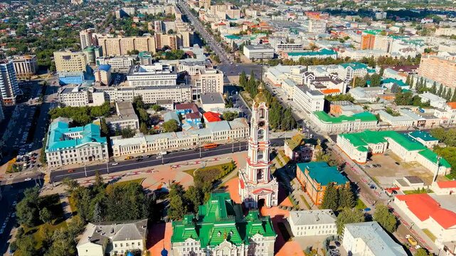 Tambov, Russia. The 107-meter neoclassical belfry of the Monastery of Our Lady of Kazan, soaring above the city skyline in a sweeping Drone footage under bright summer sun. Drone footage, Point of in