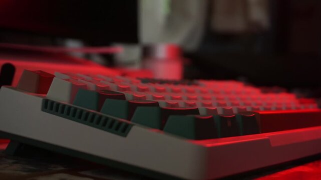 A close up low angle side view of a mechanical keyboard without hands, featuring dynamic illumination that smoothly transitions through vibrant shades of blue, green, and purple.