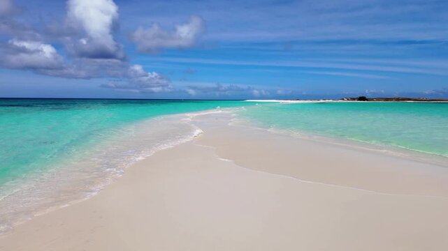 POV walking towards the Cayo de Agua sandbar in Los Roques Archipelago Venezuela, no people, revealing pristine white sand and crystal clear turquoise Caribbean waters in a untouched tropical island