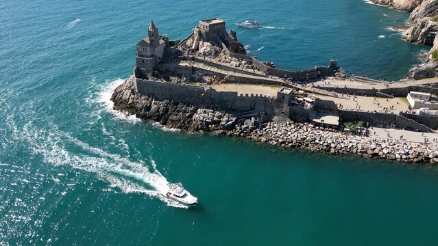 Italy, Liguria, The Church of San Pietro in Portovenere in the province of La Spezia, perched on a rocky spur overlooking the sea, is a Gothic-Genoese jewel from the 13th century - drone view 