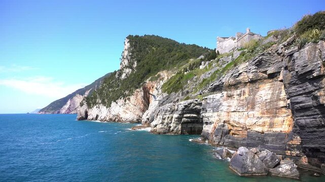 Italy, Liguria, The Church of San Pietro in Portovenere in the province of La Spezia, perched on a rocky spur overlooking the sea, is a Gothic-Genoese jewel from the 13th century - drone view 