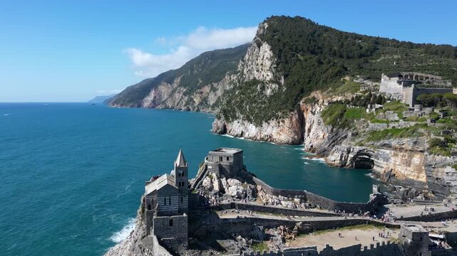 Italy, Liguria, The Church of San Pietro in Portovenere in the province of La Spezia, perched on a rocky spur overlooking the sea, is a Gothic-Genoese jewel from the 13th century - drone view 