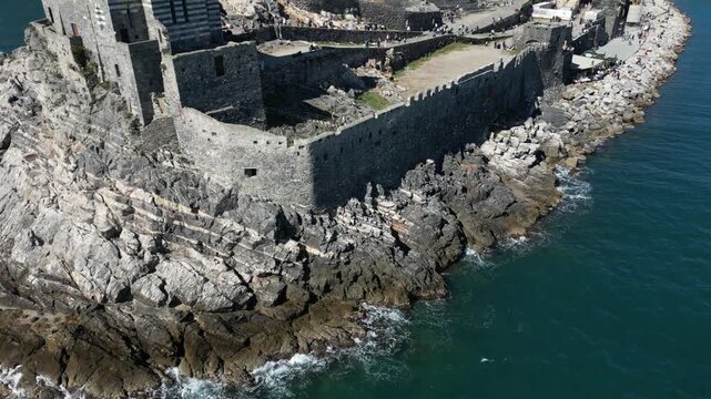 Italy, Liguria, The Church of San Pietro in Portovenere in the province of La Spezia, perched on a rocky spur overlooking the sea, is a Gothic-Genoese jewel from the 13th century - drone view 