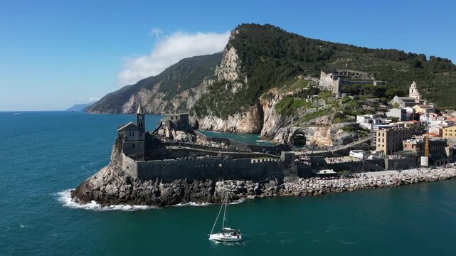 Italy, Liguria, The Church of San Pietro in Portovenere in the province of La Spezia, perched on a rocky spur overlooking the sea, is a Gothic-Genoese jewel from the 13th century - drone view 