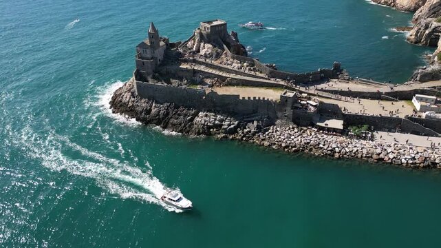 Italy, Liguria, The Church of San Pietro in Portovenere in the province of La Spezia, perched on a rocky spur overlooking the sea, is a Gothic-Genoese jewel from the 13th century - drone view 