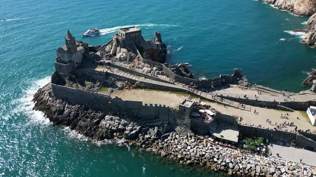Italy, Liguria, The Church of San Pietro in Portovenere in the province of La Spezia, perched on a rocky spur overlooking the sea, is a Gothic-Genoese jewel from the 13th century - drone view 
