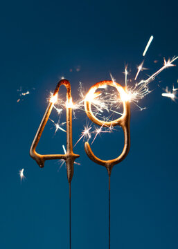49 years celebration festive background made with Bengal fires in the form of number forty nine. Vertical photography.
