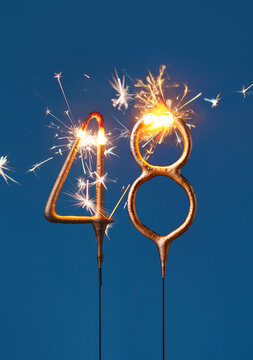 48 years celebration festive background with copy space made with Bengal fire in the form of number Fourty eight. Vertical photography.