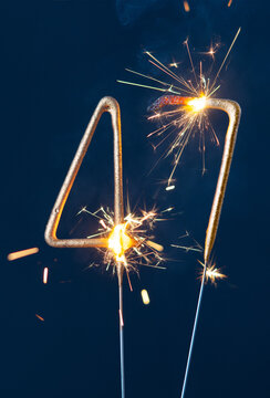47 years anniversary celebration festive background made with Bengal fires in the form of number Forty seven. Vertical photography.