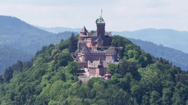 Aerial view of Chateau du Haut-Koenigsbourg on a forested mountain peak in the Vosges near Selestat, Grand Est, France.