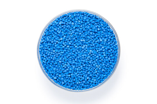 Blue masterbatch granules in a glass bowl isolate on white background. Masterbatch is a new type of colorant specifically for polymer materials. Top view