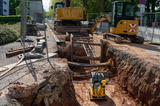 excavator on a construction site in the city with Vibratory plate