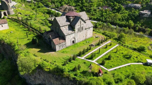 Aerial view of Akhtala Monastery, a medieval fortified Armenian monastery in Lori Province, northern Armenia. Historic Christian complex surrounded by forested hills and mountainous landscape.