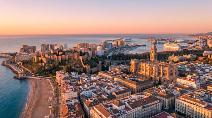 Fototapeta premium Aerial view of Malaga city skyline at sunset with the cathedral and coastline.