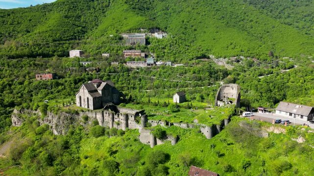 Aerial view of Akhtala Monastery, a medieval fortified Armenian monastery in Lori Province, northern Armenia. Historic Christian complex surrounded by forested hills and mountainous landscape.