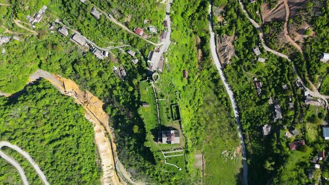 Aerial drone video of Akhtala Monastery and its surrounding landscape in Lori Province, Armenia. Historic medieval monastery complex surrounded by mountains, forests, and rural scenery in Armenia.