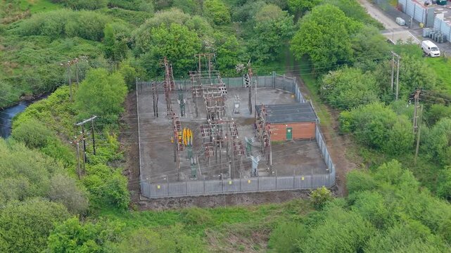 Orbiting Aerial of High-Voltage Electrical Substation featuring power transformers, circuit breakers. Critical infrastructure of a modern power grid, energy distribution, industrial engineering.
