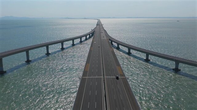 Aerial vehicle driving on cross sea bridge，aerial bridge China, offshore bridge drone, Guangdong infrastructure, China engineering, sea link bridge, mega bridge aerial, civil engineering landmark, sus