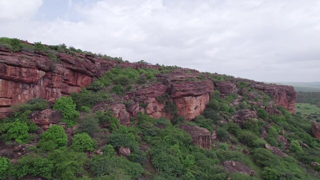 Drone view of historic Badami Caves with natural terrain and rugged rocky formations