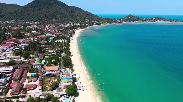 Fly backwards over Lamai beach on a sunny day