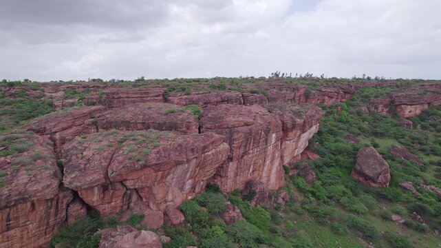 Drone view of historic Badami Caves with natural terrain and rugged rocky formations