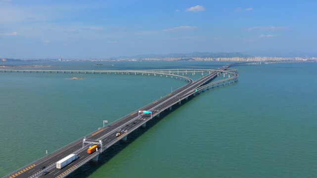 Aerial view of Jiaozhou Bay Bridge , Qingdao, China &mdash; modern sea-crossing highway over calm ocean waters，Aerial vehicle driving on cross sea bridge