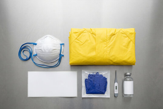 Protective hazmat gear flat lay with blank white medical label