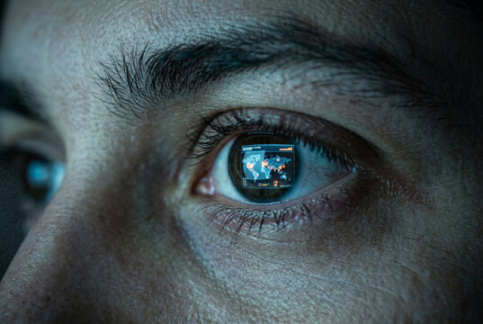 Human eye reflecting glowing world map displaying global data connections and outbreaks