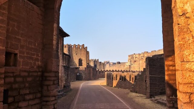 Sharza Darwaza entrance with side wall, road and Gumbad Darwaza at bidar fort, karnataka, india. day time, trucking shot, hand held shot, 4k.