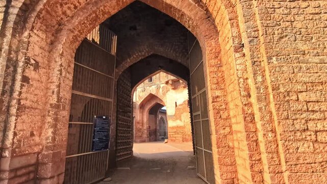 Fort entrance arch of Sherja Darwaza Gate with old wooden doors and Sharza Darwaza at bidar fort, karnataka, india. day time, zib shot, hand held shot, 4k.