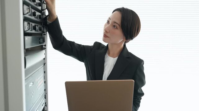 サーバーを点検する女性エンジニア