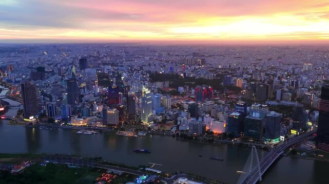Aerial drone view of Ho Chi Minh City skyline and Ba Son Bridge at sunset, Vietnam