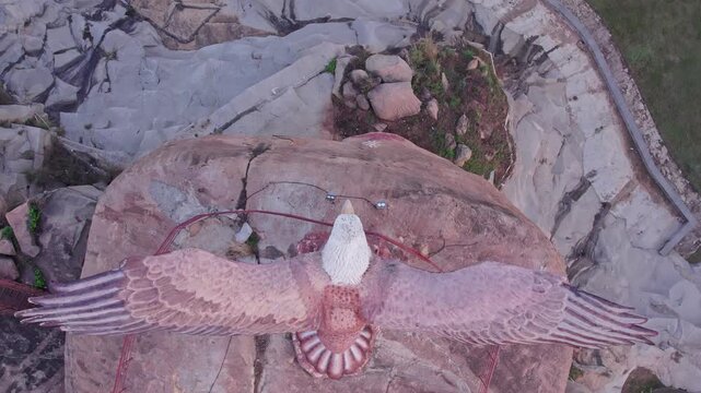 High angle view of Jatayu Garuda statue with outstretched wings on rock