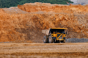 Mining dump truck at open pit quarry with gold ore for industrial construction site © Parilov