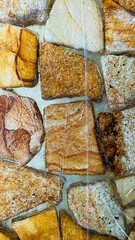 Fototapeta premium Abstract close up of natural stone wall background with detailed brown veins