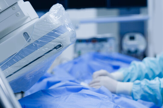 Cardiac catheterization lab with imaging equipment and medical monitor for hospital diagnostic