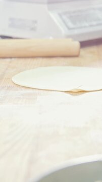Cook bakes, roll out the dough for the pie