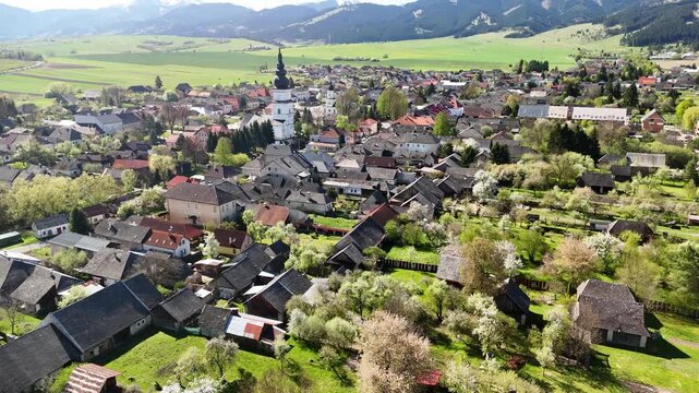 Aerial view of the historic village of Partizanska Lupca with its church tower and traditional houses surrounded by green fields Partizanska Lupca, Zilina Region, Slovakia.