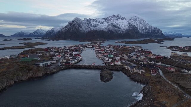 Beautiful winter views of a coastal town with mountain background in Norway