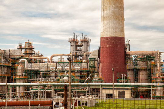 Industrial complex stands tall under cloudy sky