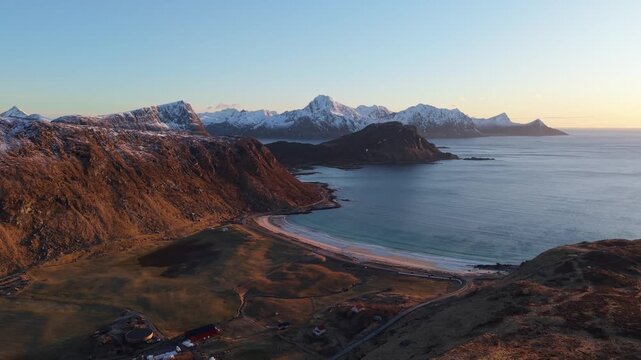 Beautiful coastal landscape during sunset with mountains and beach views in Norway