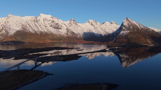 Drones capture mountains and water at sunset in Norway with clear reflections