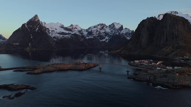 Majestic mountains and water views at dawn near a quiet village in Norway's Lofoten Islands