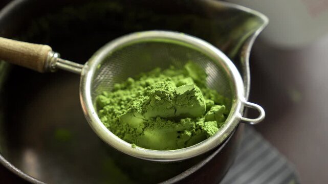 Traditional Japanese tea preparation with matcha powder detail