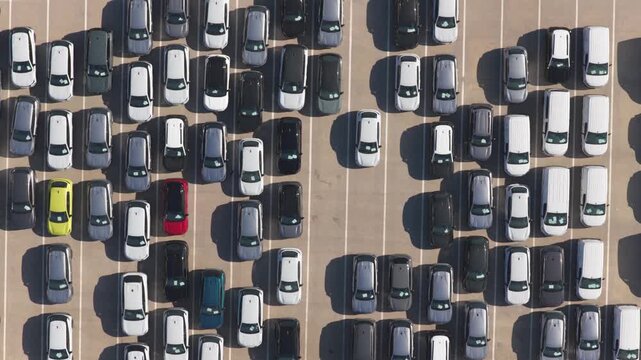 Numerous new vehicles neatly arranging themselves in a large automotive factory parking lot, showcasing the efficiency of modern vehicle manufacturing, distribution, and logistics industry