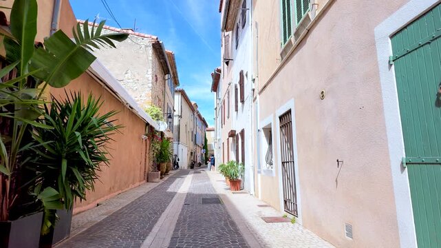 Narrow Cobblestone Street with Potted Plants in Cassis France